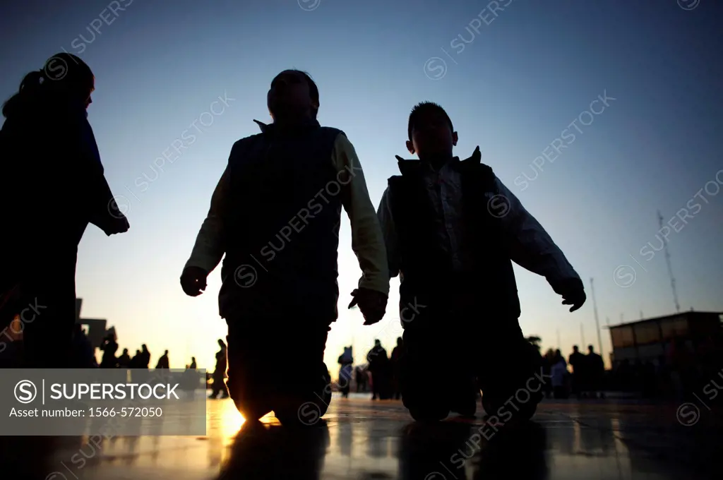 Pilgrims walk on their knees toward the Basilica of Guadalupe at sunrise in Mexico City. Hundreds of thousands of Mexican pilgrims converged on the Ba...