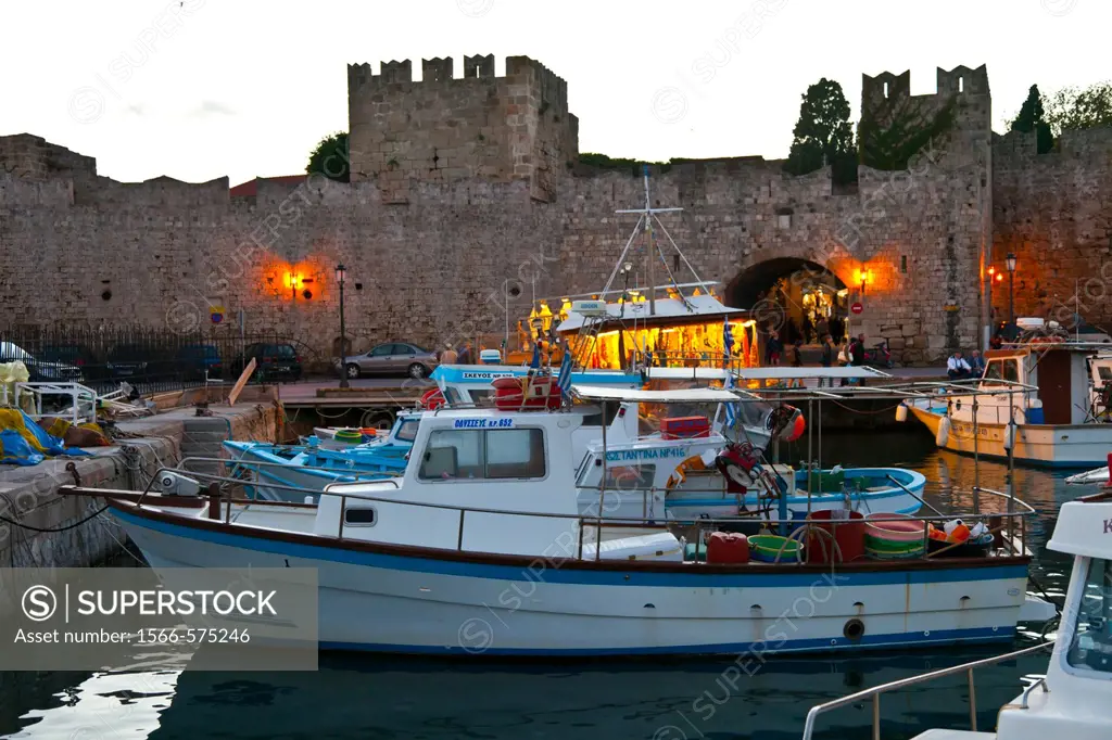 Fishing boats and walls at the commercial port, City of Rhodes, Rhodes Island, Dodecanese, Greece, Mediterranean Sea.