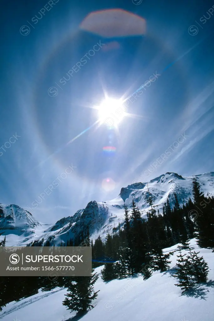 Sundog and lens flare in sky over Never Summer mountains in winter, Colorado, USA