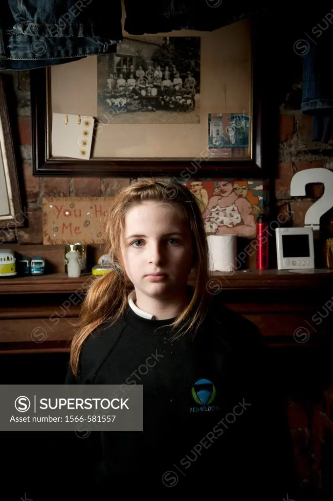 Interior, Sullen looking 12 year old girl, facing the camera, UK