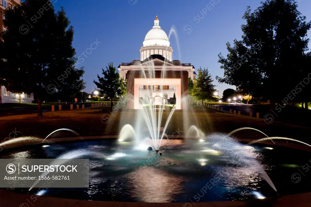 The Arkansas state capitol building illuminted at dusk in Little Rock, Arkansas, USA,