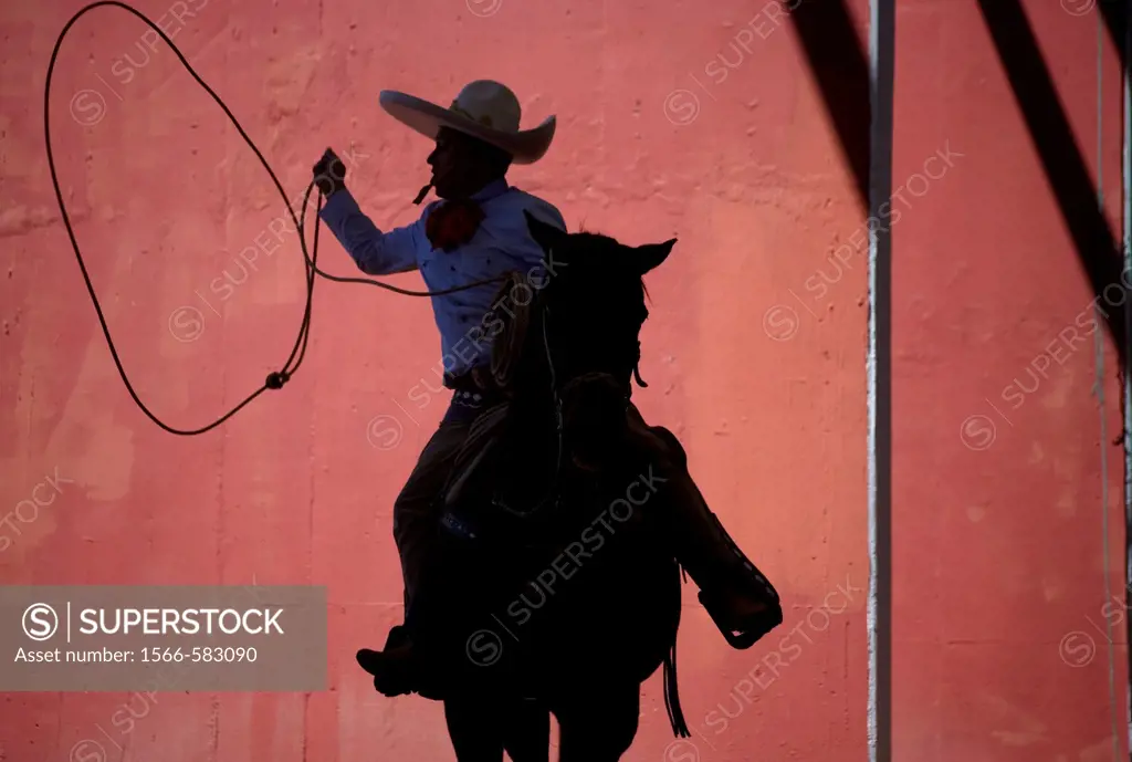 A Mexican charro practices his lasso at the National Charro Championship in Pachuca, Hidalgo State, Mexico. Escaramuzas are similar to US rodeos, wher...