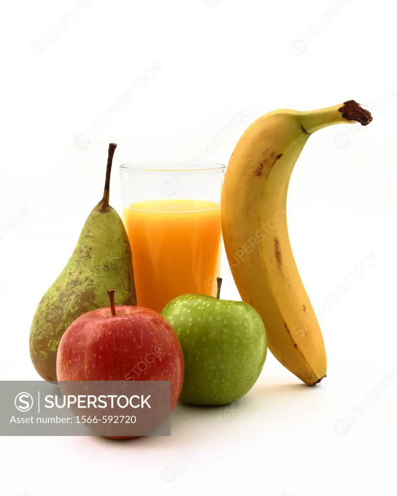 A glass of orange juice with a banana, red and green apples and a pear on a white background.