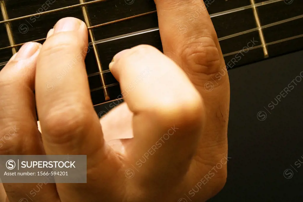 A close up view of musician´s hand on guitar