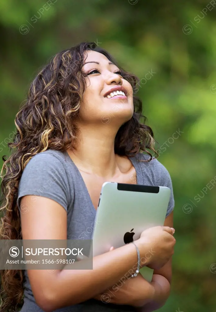 Close up of a happy young woman hand holding an iPad