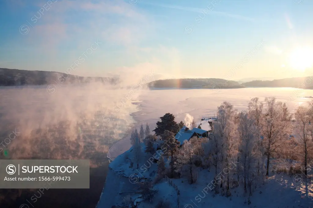Clouds of steam rise over a freezing river on a very cold winter day in Sweden