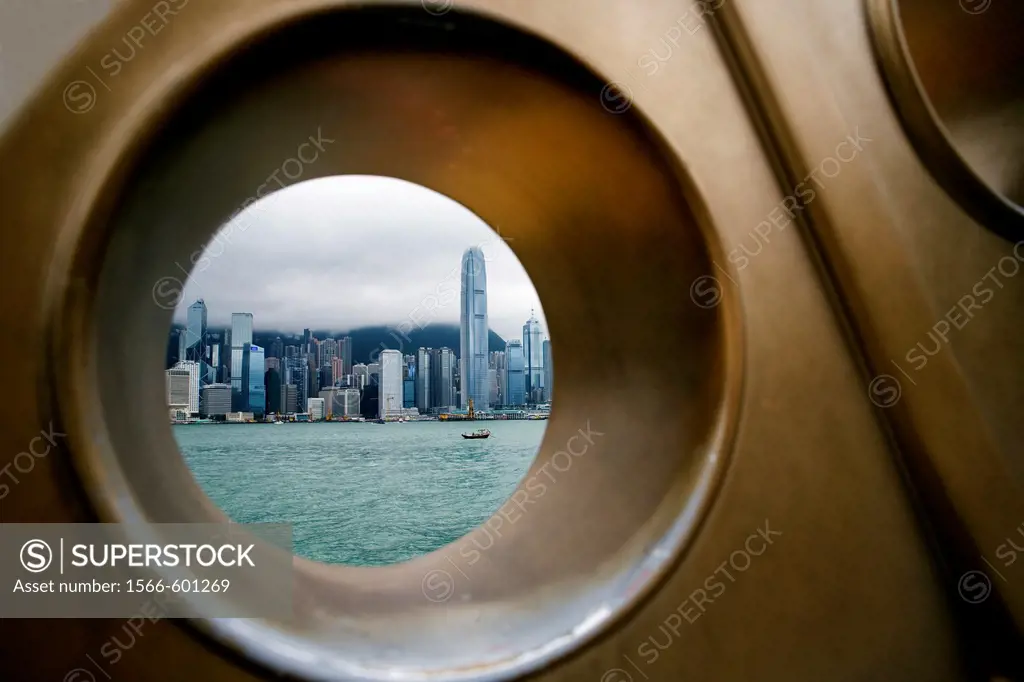 CHINA HONG KONG HONG KONG COASTLINE VICTORIA HARBOUR View of Hong Kongs coastal frontline skyline shoot through a hole, part of a bronze sculpture at...