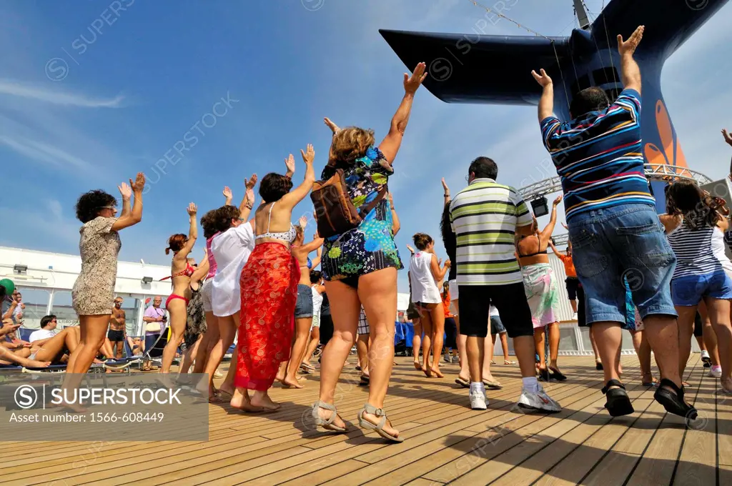 People dancing on the deck of a cruise ship