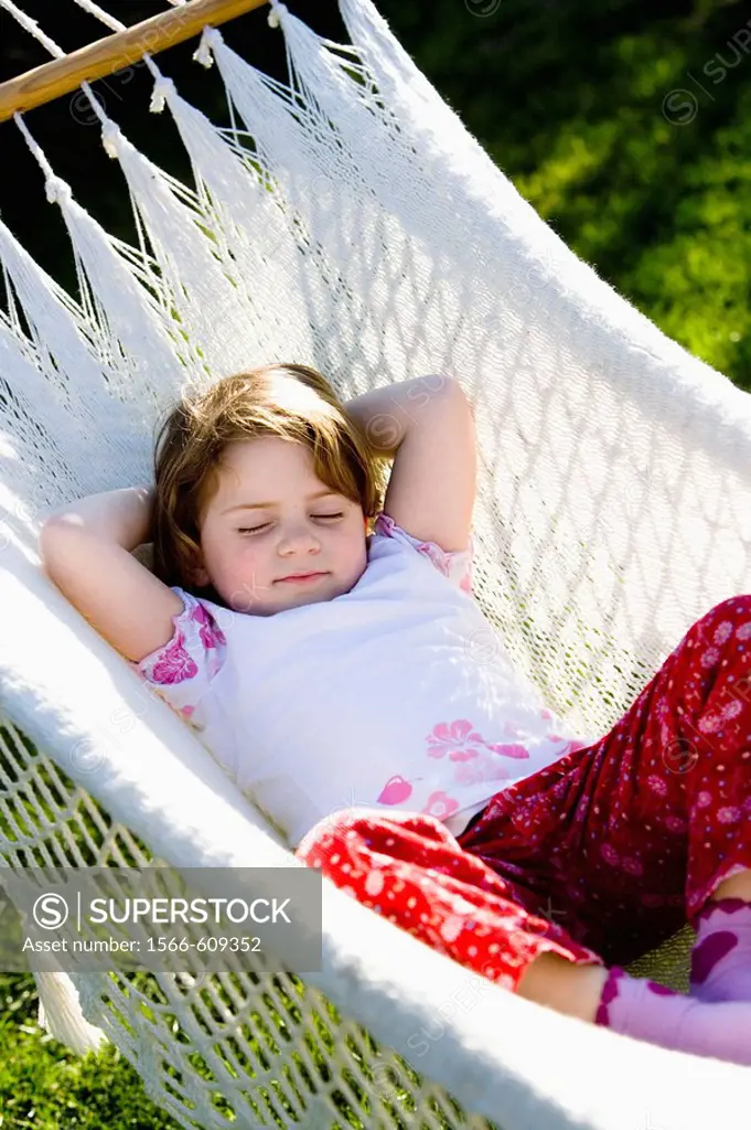 Little girl sleeping on a hammock