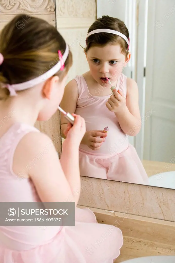 Little girl applying make up