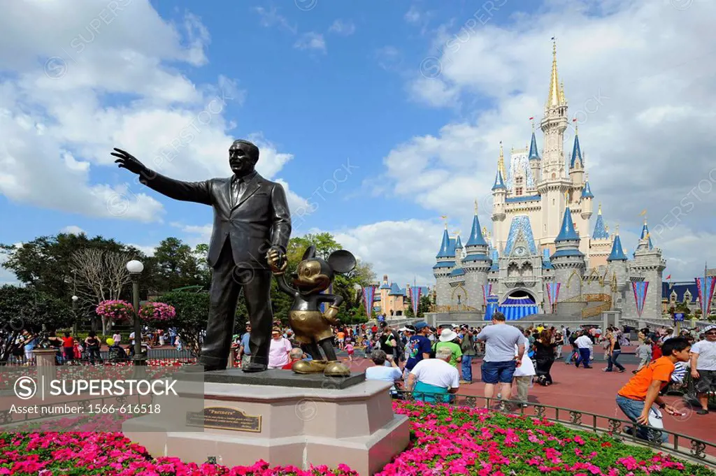 Statue of Walt Disney and Mickey Mouse in front of Cinderella Castle at Magic Kingdom Theme Park Orlando Florida Central