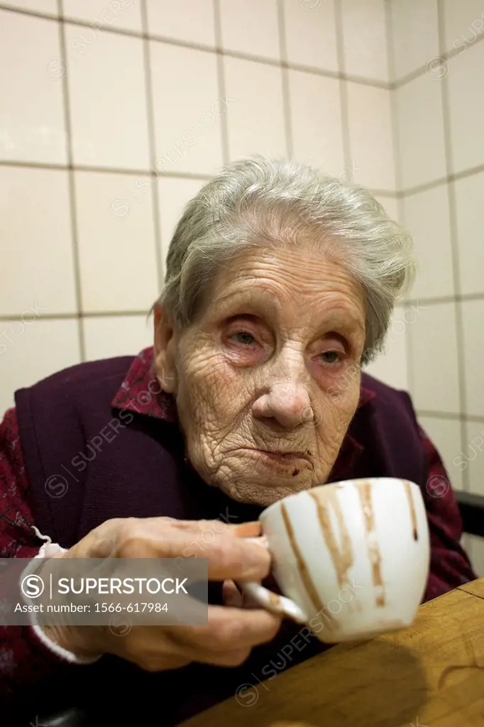 Old woman drinking chocolate