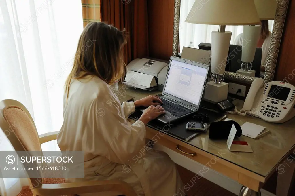 Woman business traveler at hotel on laptop