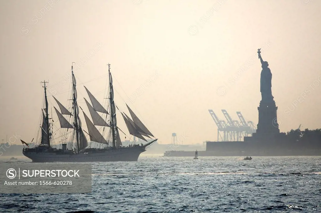 A sailing ship and Statue of Liberty in Upper New York Bay, New York City. USA