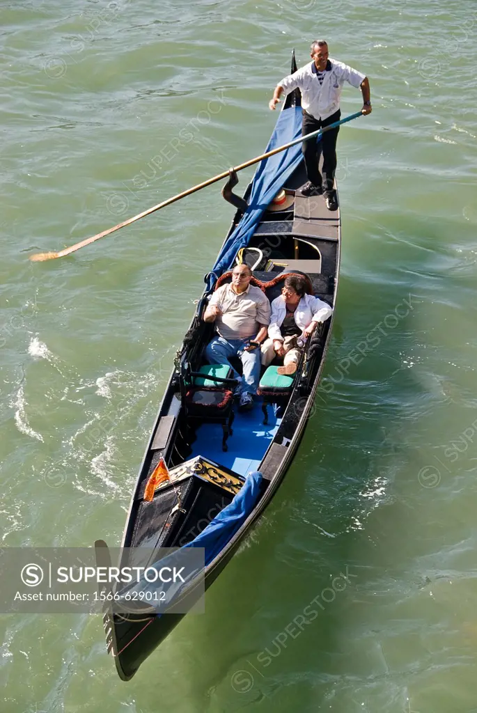 Tourist travelling on a gondola, Venice, Italy, Europe