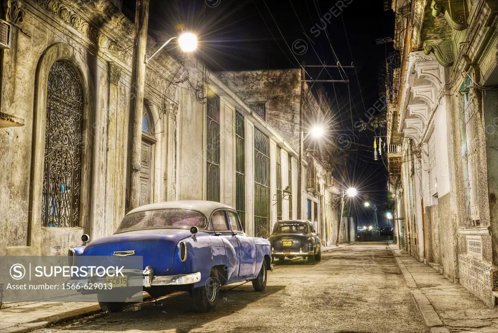 Vintage cars parked in the street at night  Ciudad de La Habana, Cuba, Caribbean
