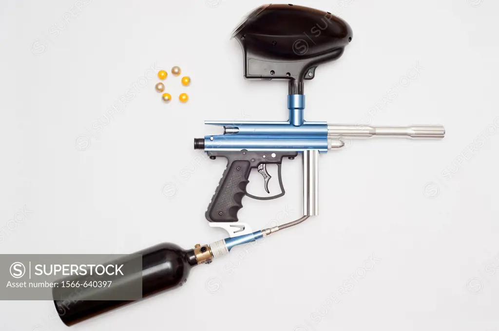 A paintball gun complete with gas canister and paintballs ammunition on a white background