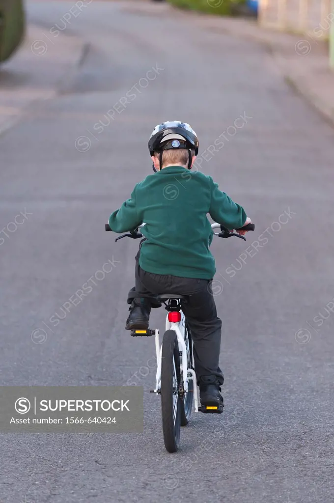 A seven year old boy riding his BMX bike in the Uk