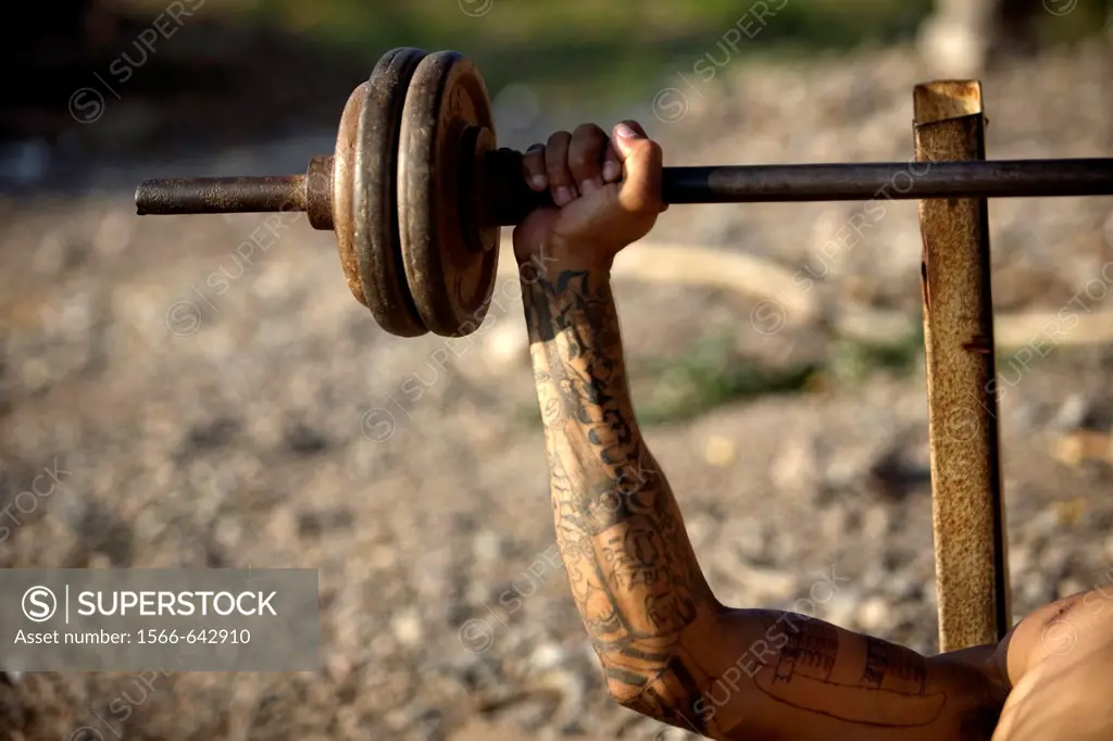 A Central American migrant traveling across Mexico to work in the United States trains with weights at the Catholic priest Alejandro Solalinde´s shelt...