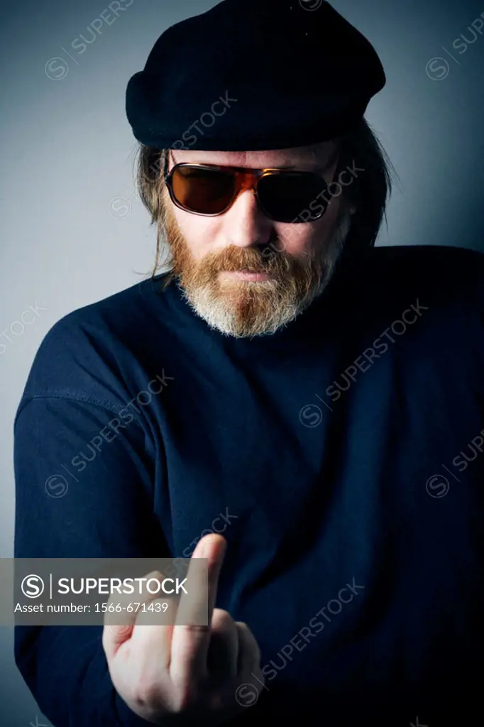 Man with sunglasses making obscene gesture showing middle finger ´Fuck off´ gesture.