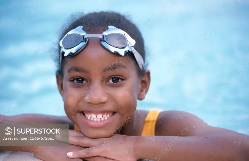 girl poolside in swim goggles