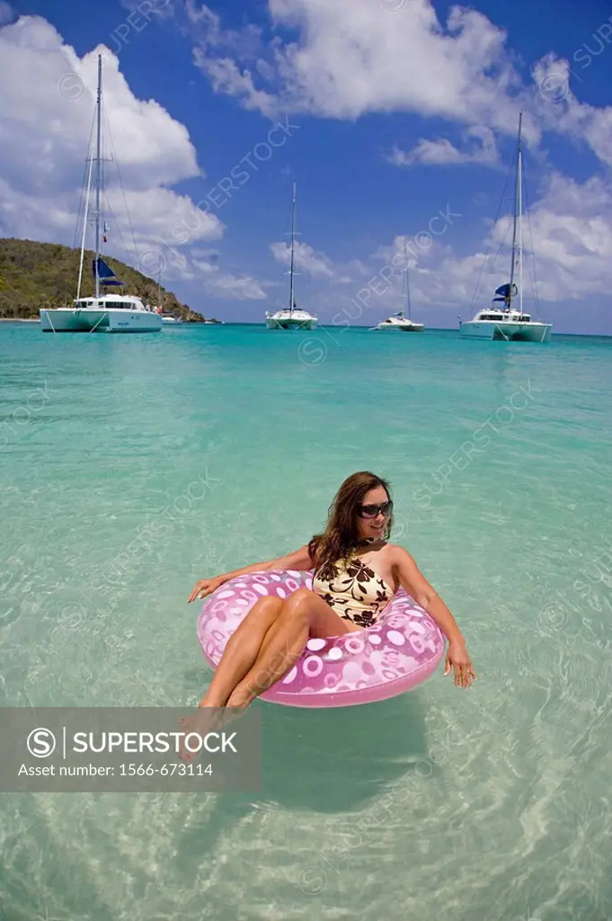 Woman floating on an inflatable tube  Salt Whistle Bay in St Vincent and the Grenadines