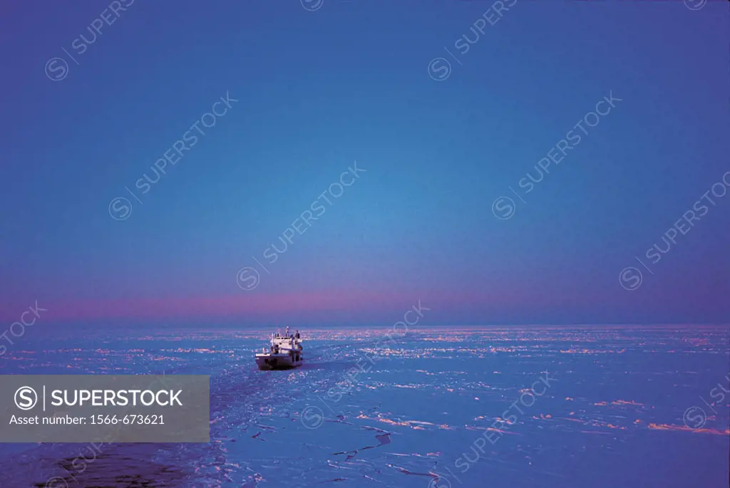 Shipping cargo ship, ice, sea, night, blue, cold. Sweden