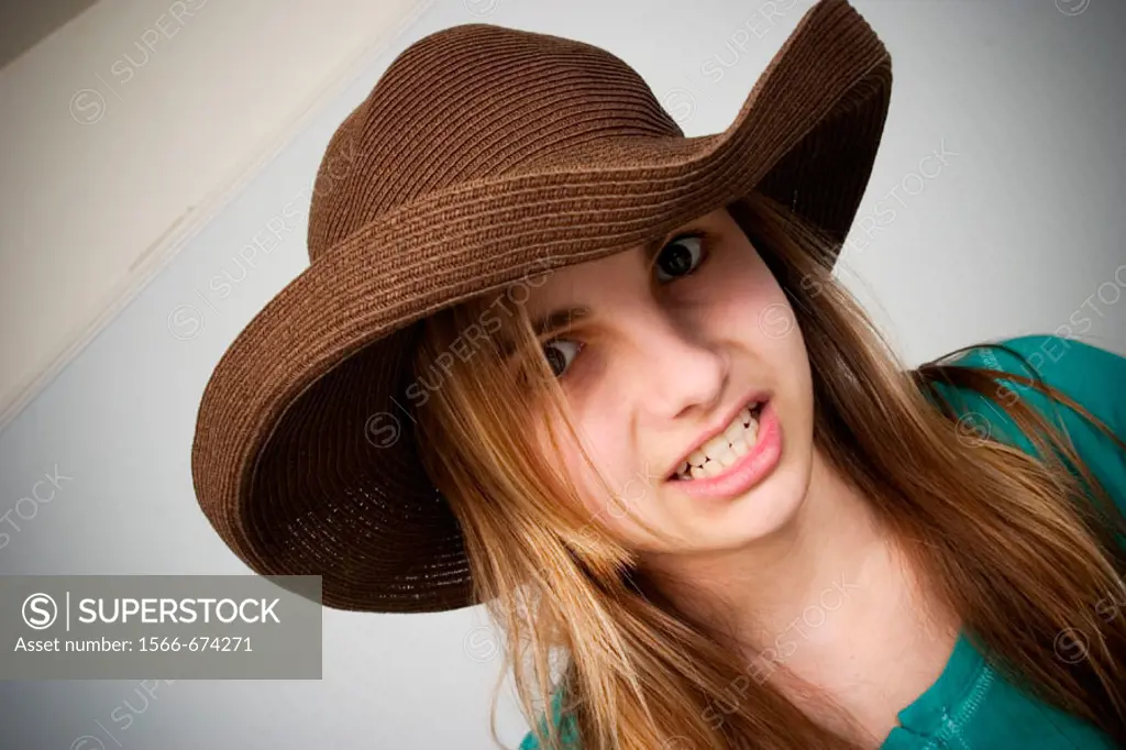 Long blond-hair teen girl wearing a hat