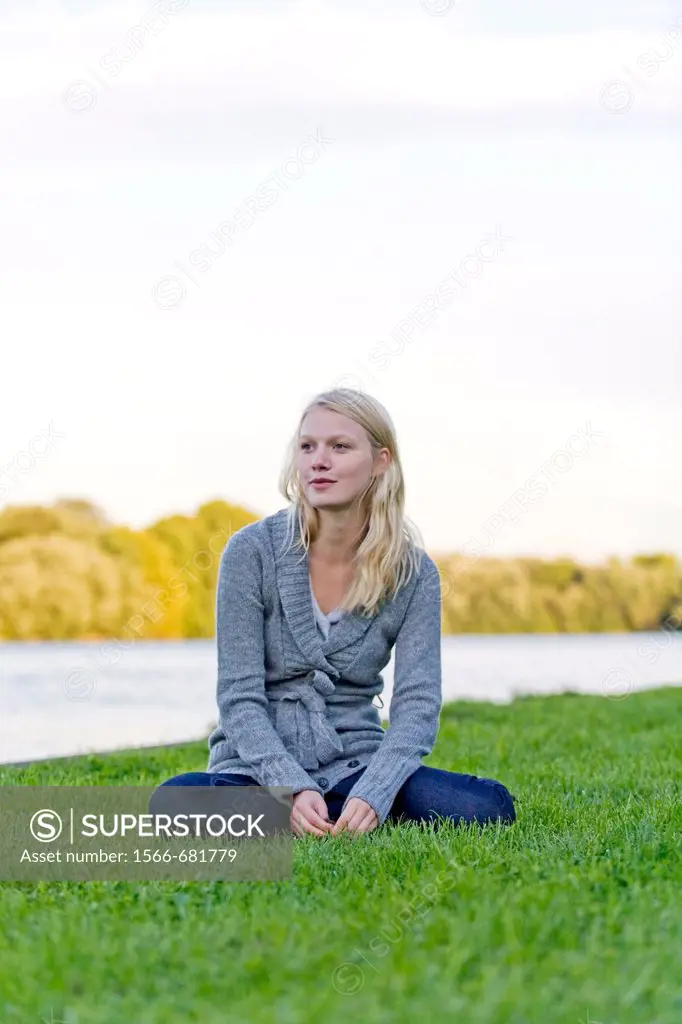 Portrait of a blonde woman sitting in the park