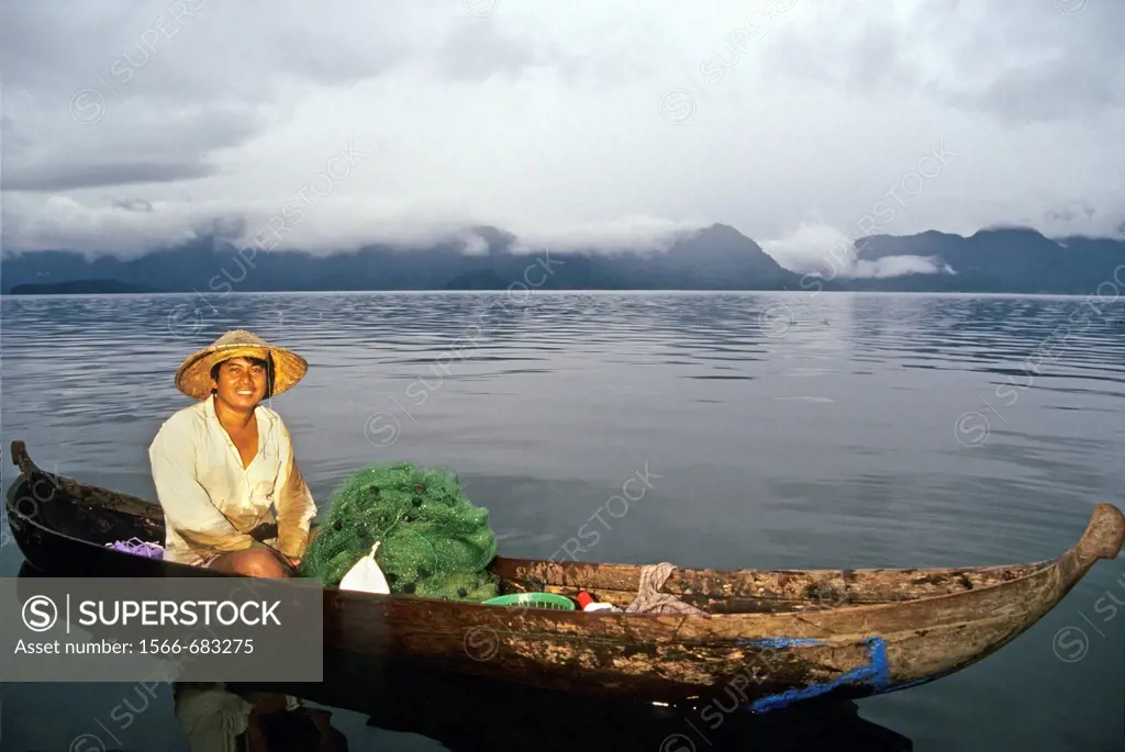 fisherman with dugout on the lake Maninjau, Sumatra island, Republic of Indonesia, Southeast Asia and Oceania