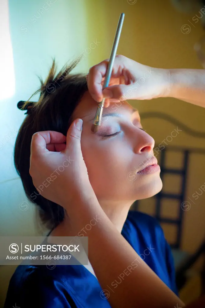 Woman receiving make-up application