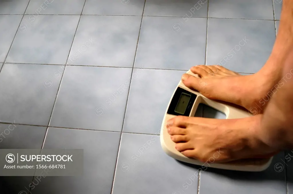 Man standing on a bathroom weight scale