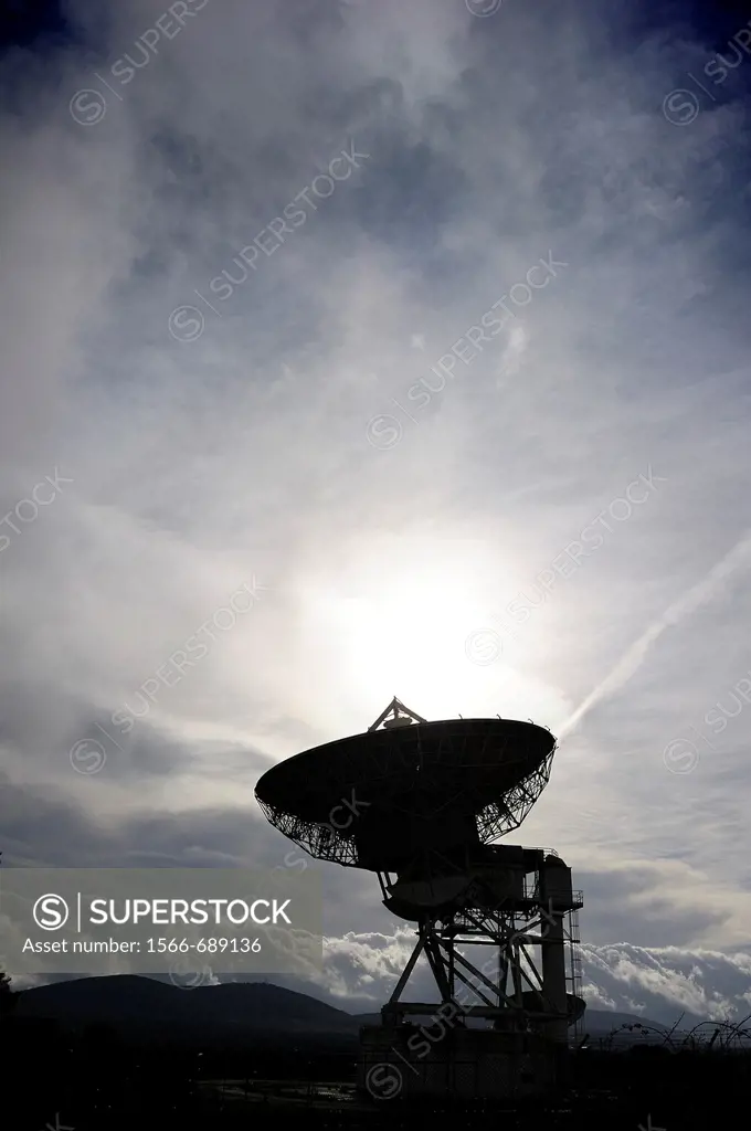Communications satellite dish photographed backlit