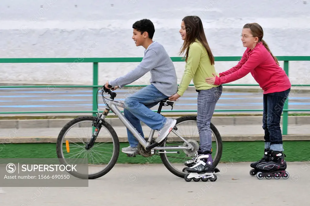 Group of children with bicycle and in-line skates. Spain.