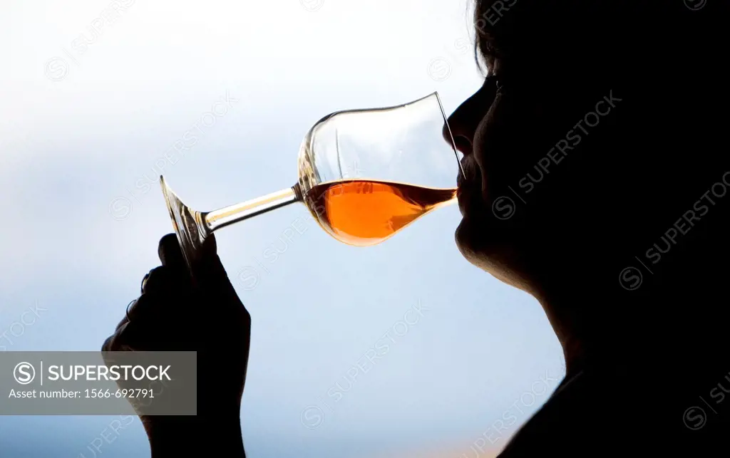 A woman drinks in a glass of red wine in Taramilla winery in Prado del Rey, Cadiz province, Andalusia, Spain, April 25, 2010