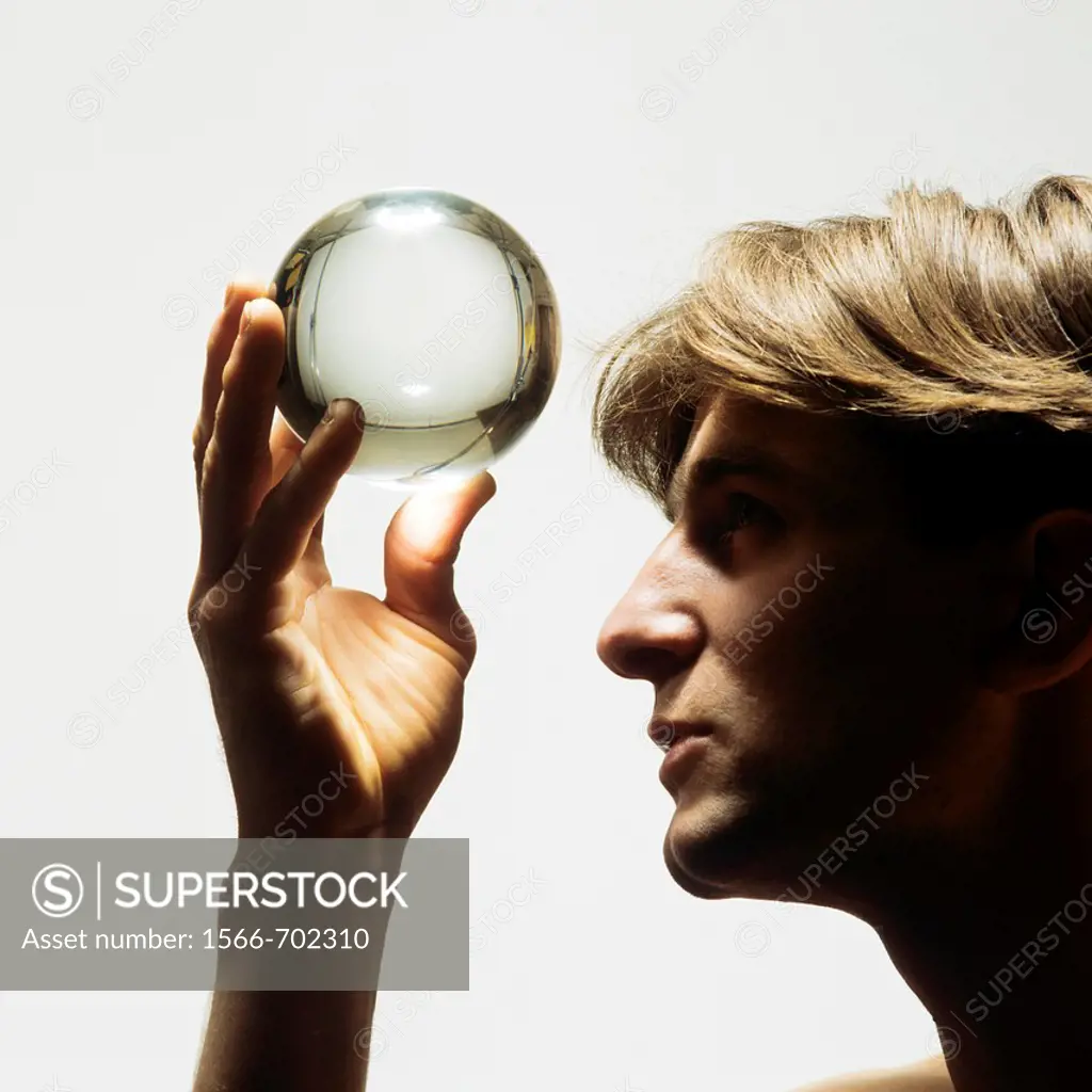 Man looking up into a crystal ball