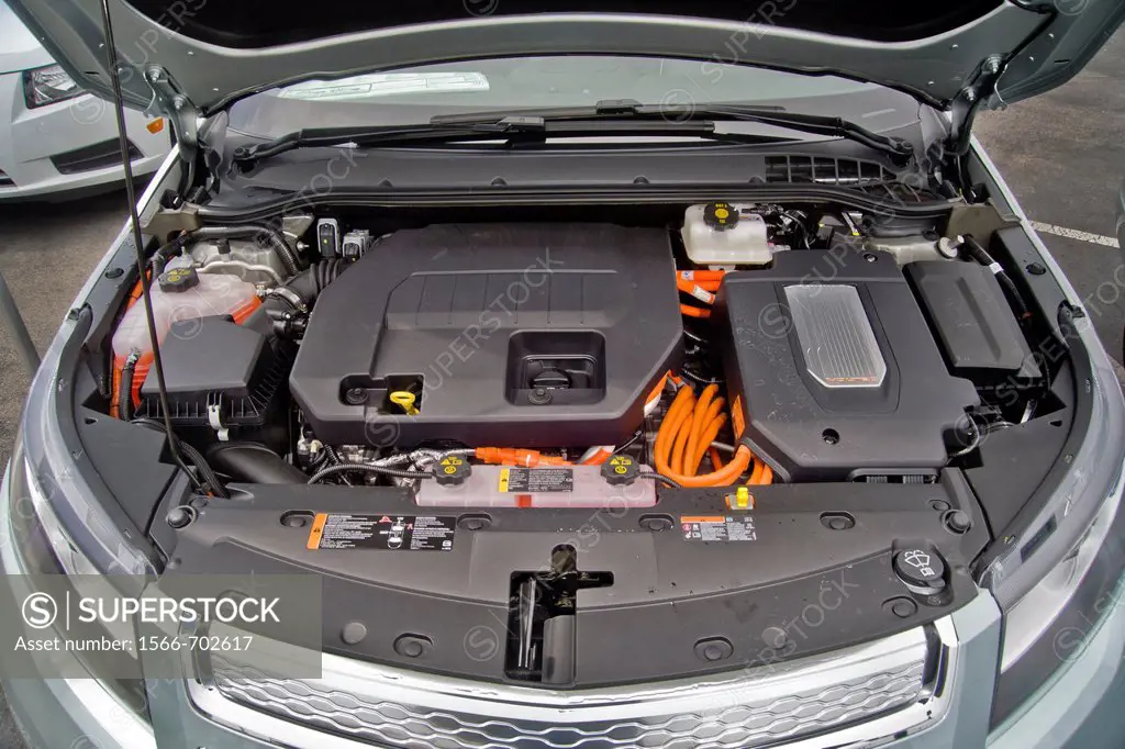 The engine compartment of a Chevrolet Volt hybrid gas/electric car  Right side: the power inverter in top of the electric motor  Left side: the 1 4-li...