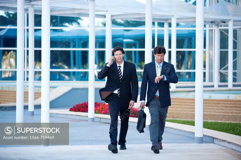 Twin businessmen in a hurry