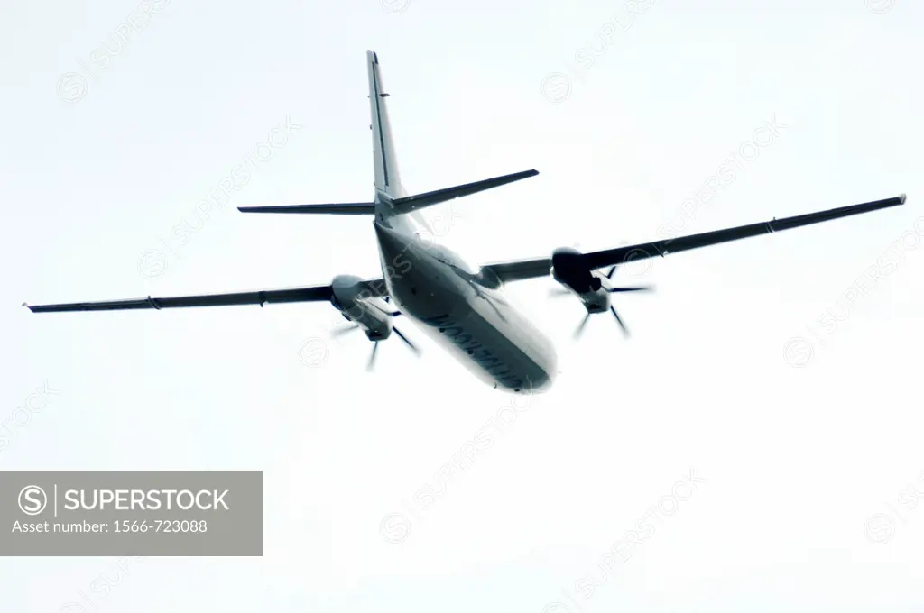Turboprop aircraft in bright sky