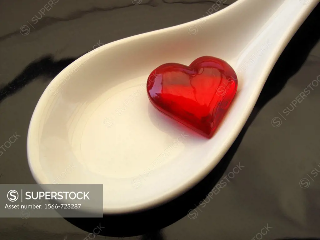 Small glass heart is in medicine spoon