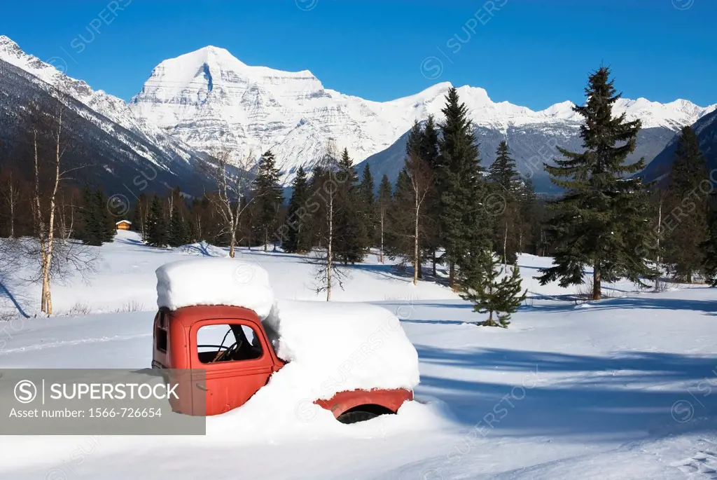 Abandoned 1950´s era red truck covered in snow, Mount Robson Provincial Park British Columbia Canada