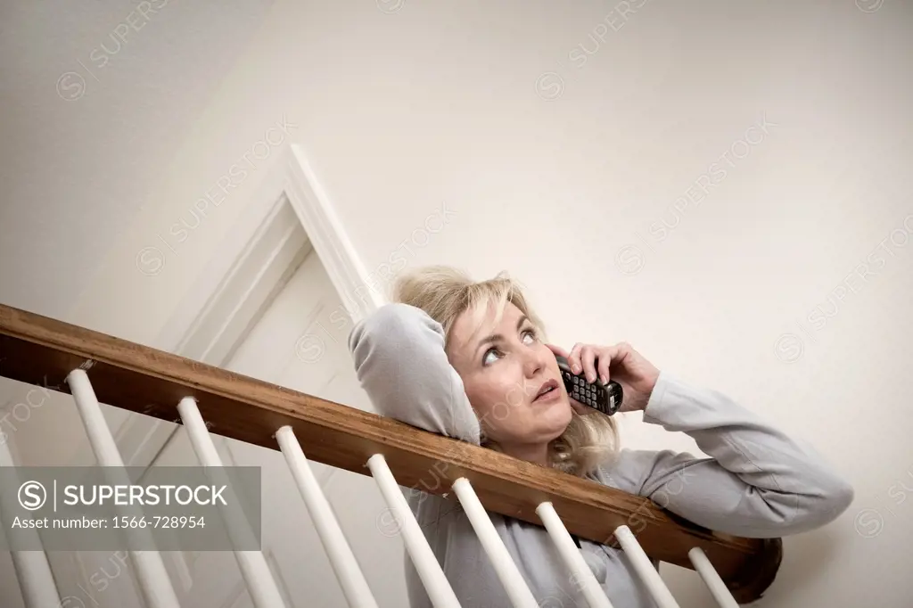 Middle-age blond woman talking on her telephone