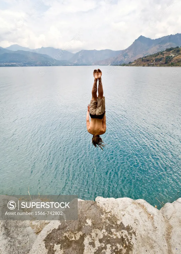 Guatemala, San Marcos La Laguna, man jumping off cliff
