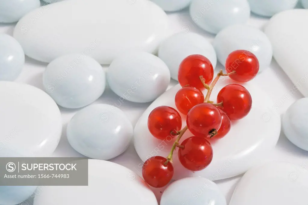 Close-up of red currants on white pebble stones