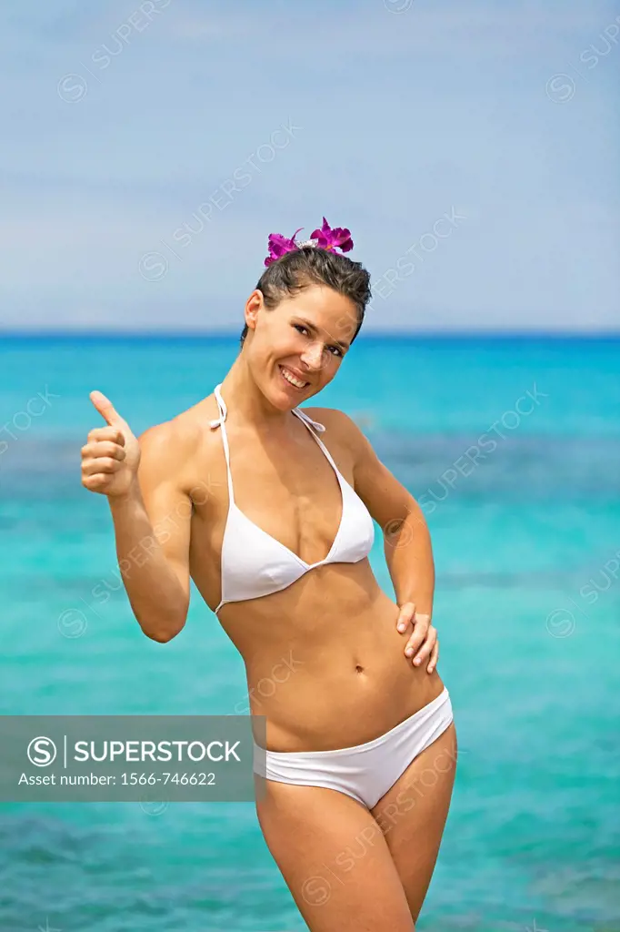 Portrait of a content brunette woman at the beach