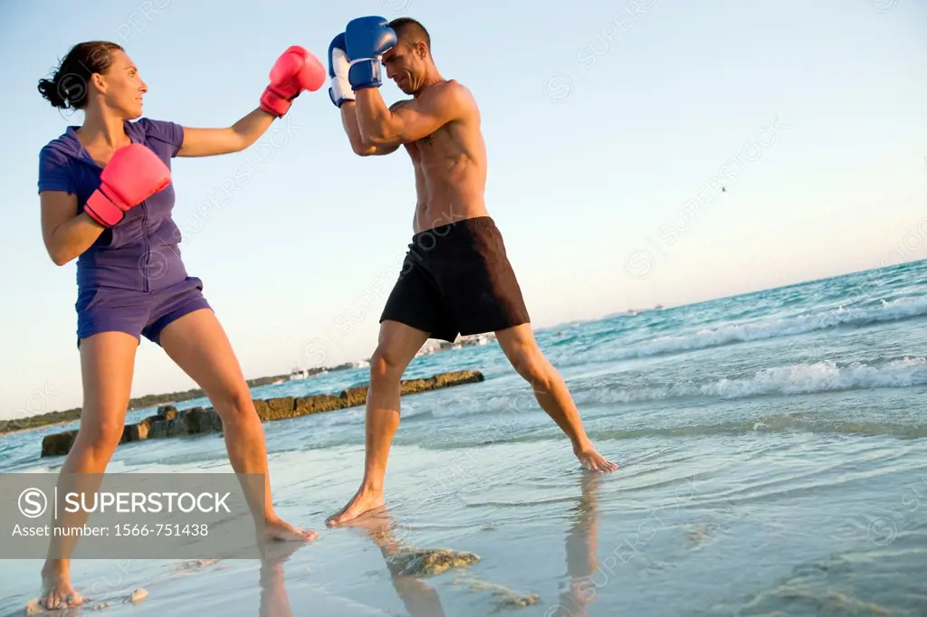 Couple boxing on the beach