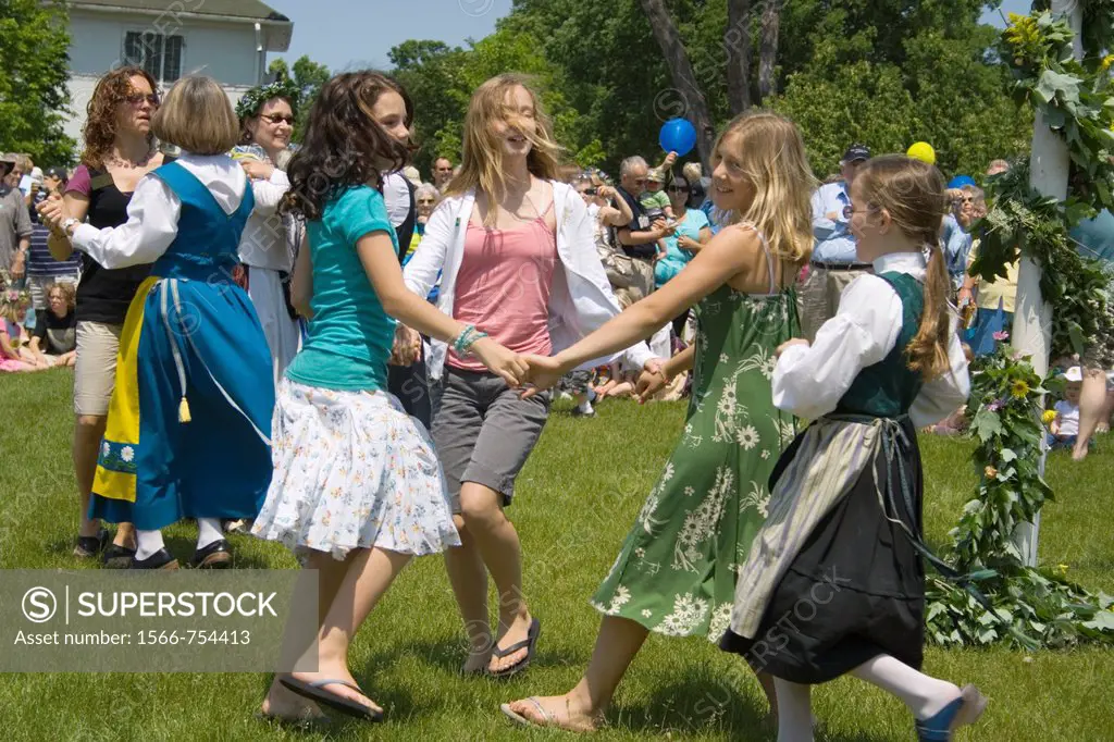 Teens dancing around the Maypole celebrating Midsommar at the Swedish Institute  Midsommar Minneapolis Minnesota MN USA