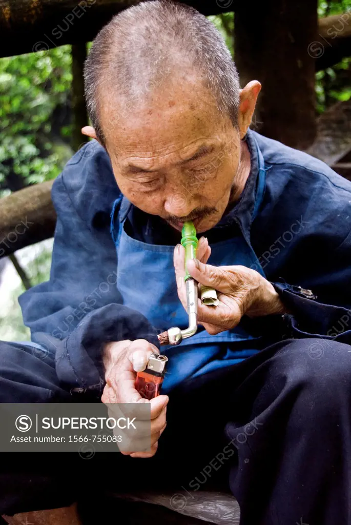 Old chinesse man smoking a pipe  Emei Shan, Sichuan, China