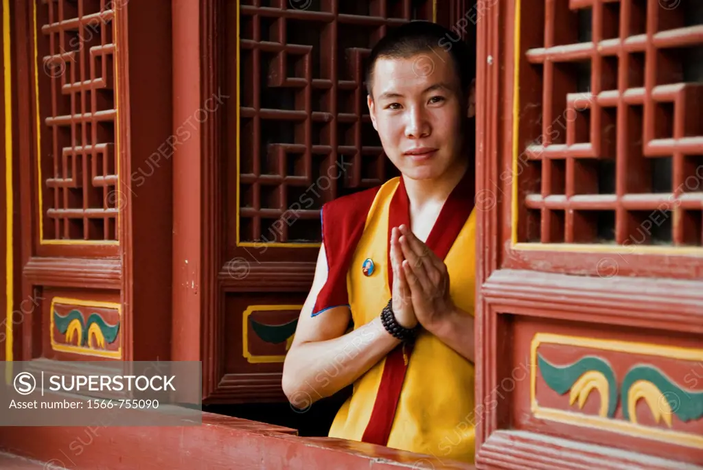 Budhist monk doing the traditional greeting in a temple  Lama Temple, Xian, Shaanxi, China