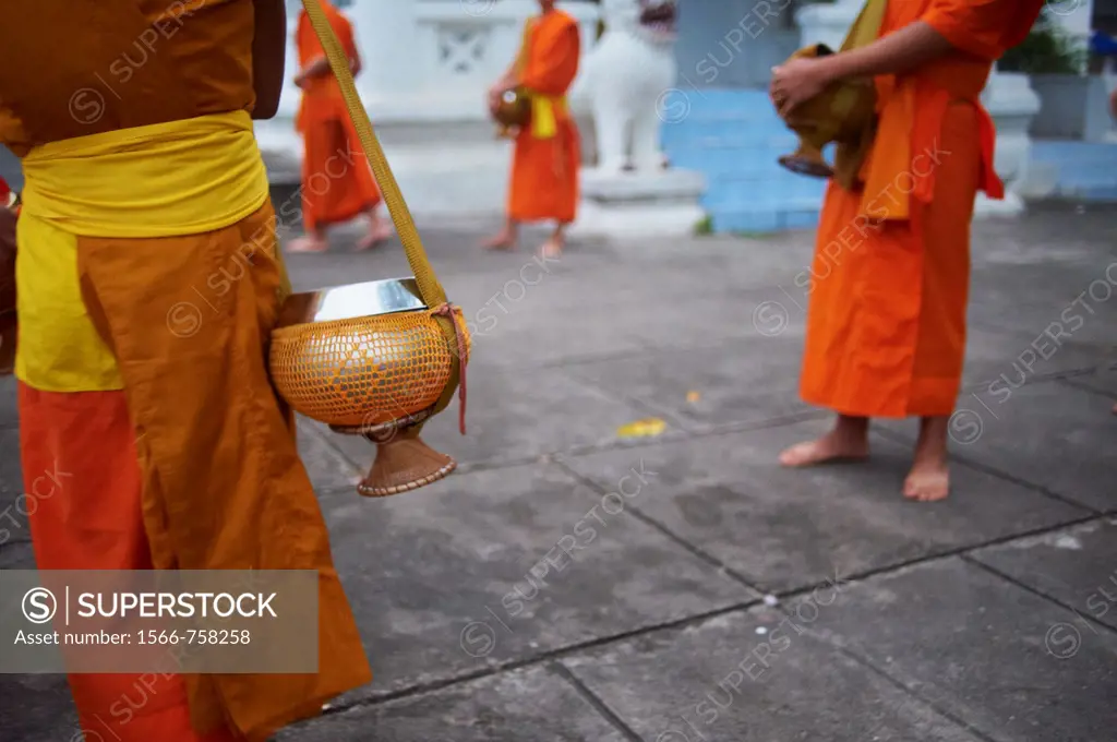 Laos, Province of Luang Prabang, city of Luang Prabang, World heritage of UNESCO since 1995, Buddhist monks procession receive offerings